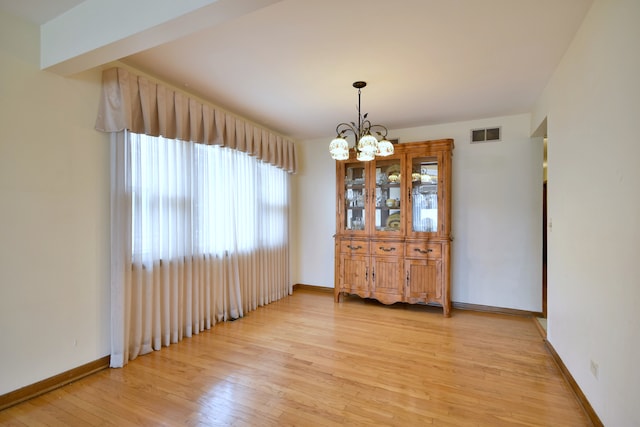 4732 N Anthon Ave, Chicago, IL 60656 - dining space with light wood finished floors, a chandelier, and baseboards