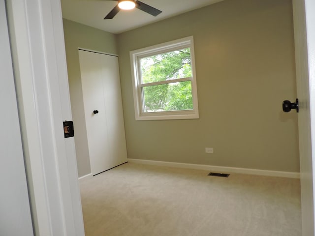 2030 University Dr, Naperville, IL 60565 - unfurnished bedroom featuring light colored carpet, baseboards, ceiling fan, and a closet