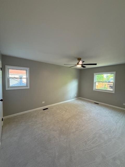 2030 University Dr, Naperville, IL 60565 - carpeted spare room with plenty of natural light, ceiling fan, and baseboards