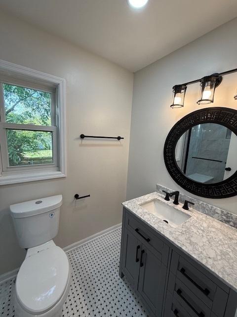 2030 University Dr, Naperville, IL 60565 - bathroom with vanity, toilet, baseboards, and tile patterned floors