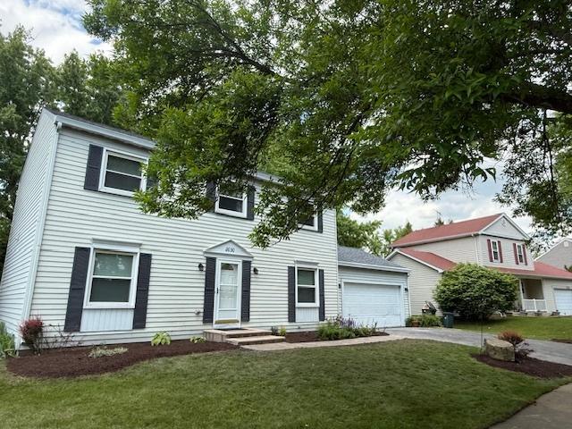 2030 University Dr, Naperville, IL 60565 - view of front of home featuring a front lawn, concrete driveway, and a garage