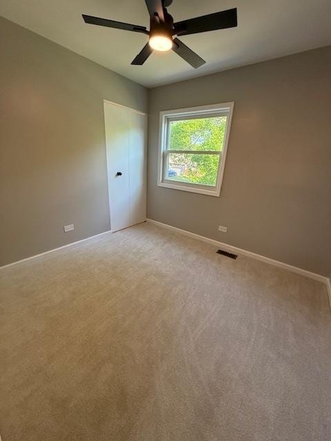 2030 University Dr, Naperville, IL 60565 - unfurnished bedroom featuring baseboards, light carpet, and a ceiling fan