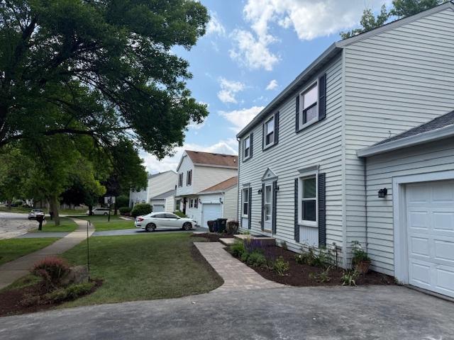 2030 University Dr, Naperville, IL 60565 - view of property exterior featuring a garage and a yard