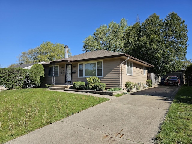 2712 W Grove Ave W, Waukegan, IL 60085 - view of front of home with a chimney, a front lawn, and driveway