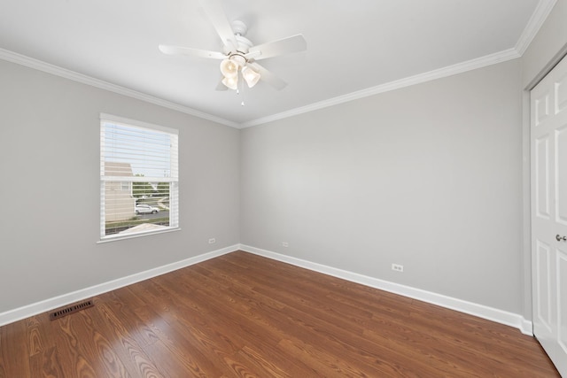 2911 Boone Ct, Joliet, IL 60435 - spare room featuring crown molding, baseboards, dark wood-type flooring, and ceiling fan