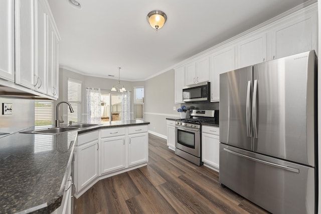 2911 Boone Ct, Joliet, IL 60435 - kitchen featuring stainless steel appliances, a sink, a peninsula, white cabinets, and dark wood-type flooring