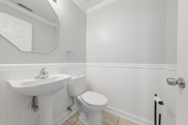 2911 Boone Ct, Joliet, IL 60435 - half bath with a wainscoted wall, toilet, tile patterned floors, crown molding, and a sink