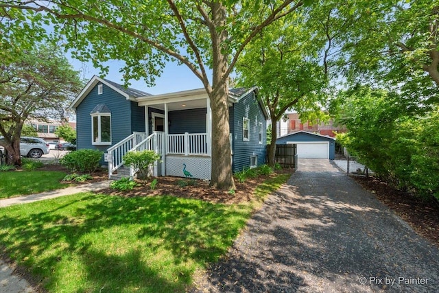 111 W N St, Plano, IL 60545 - ranch-style house featuring an outbuilding, a detached garage, a front lawn, and a porch