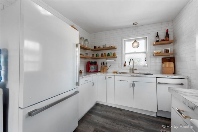 111 W N St, Plano, IL 60545 - kitchen with freestanding refrigerator, open shelves, a sink, white cabinets, and tasteful backsplash
