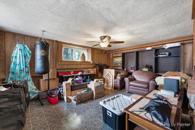 111 W N St, Plano, IL 60545 - living area with ceiling fan, wooden walls, dark flooring, and a textured ceiling