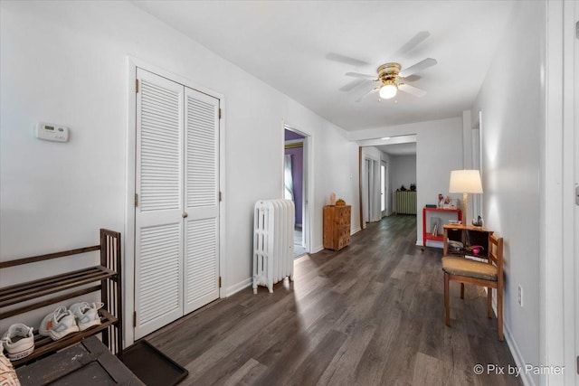 111 W N St, Plano, IL 60545 - hall featuring radiator heating unit, wood finished floors, and baseboards