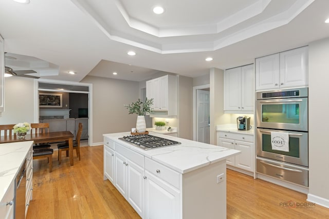 5272 Pineham Ct, Long Grove, IL 60047 - kitchen with a warming drawer, stainless steel appliances, a tray ceiling, a kitchen island, and white cabinets