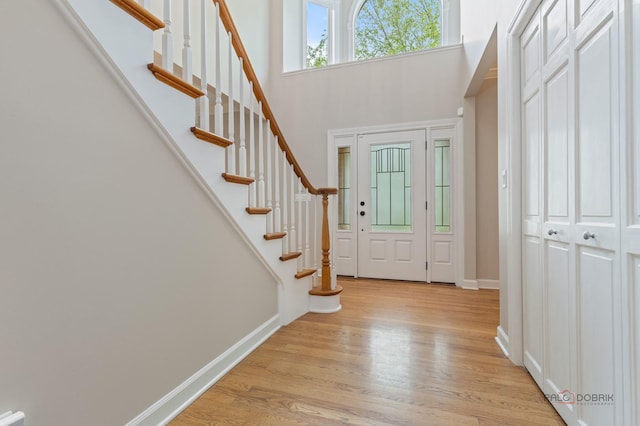 5272 Pineham Ct, Long Grove, IL 60047 - entryway with light wood-style flooring, baseboards, a towering ceiling, and stairs