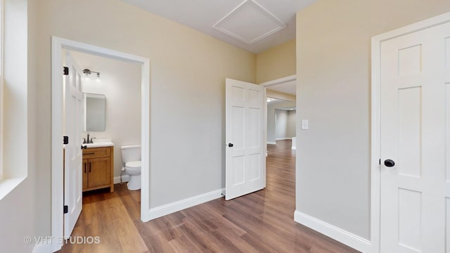 554 E Jackson St, Joliet, IL 60432 - unfurnished bedroom with attic access, wood finished floors, baseboards, and ensuite bathroom