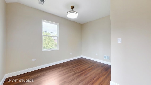 554 E Jackson St, Joliet, IL 60432 - spare room featuring dark wood-style flooring and baseboards