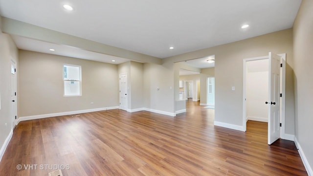 554 E Jackson St, Joliet, IL 60432 - unfurnished living room featuring wood finished floors, baseboards, and recessed lighting