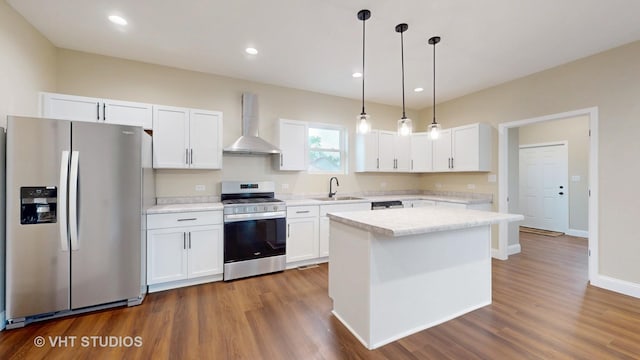 554 E Jackson St, Joliet, IL 60432 - kitchen with appliances with stainless steel finishes, wall chimney range hood, light countertops, white cabinetry, and recessed lighting