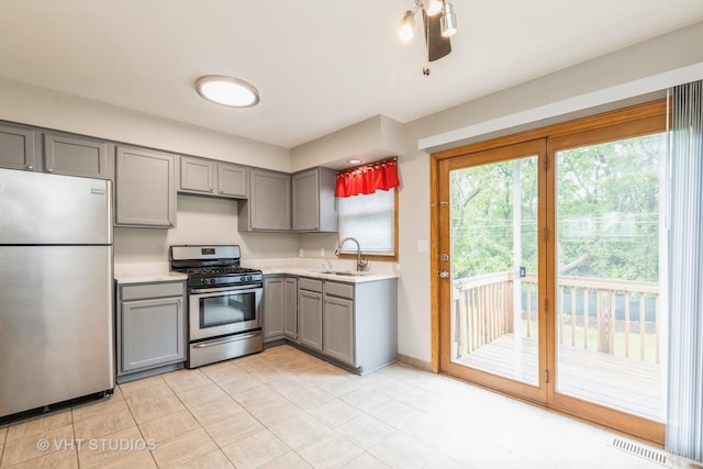 419 N Cresthill Ave, Mchenry, IL 60050 - kitchen featuring appliances with stainless steel finishes, gray cabinets, a sink, light countertops, and light tile patterned floors