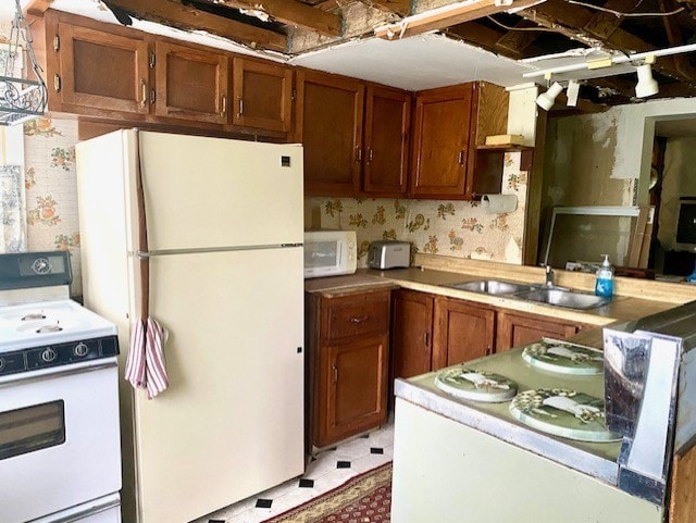 27844 1260 N Ave, Princeton, IL 61356 - kitchen with white appliances, a sink, brown cabinetry, and light countertops