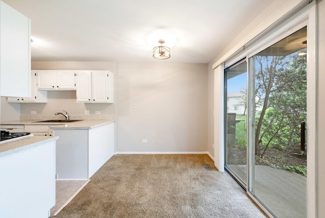 690 Thorntree Ct Unit C1, Bartlett, IL 60103 - kitchen with a sink, white cabinets, light colored carpet, light countertops, and baseboards