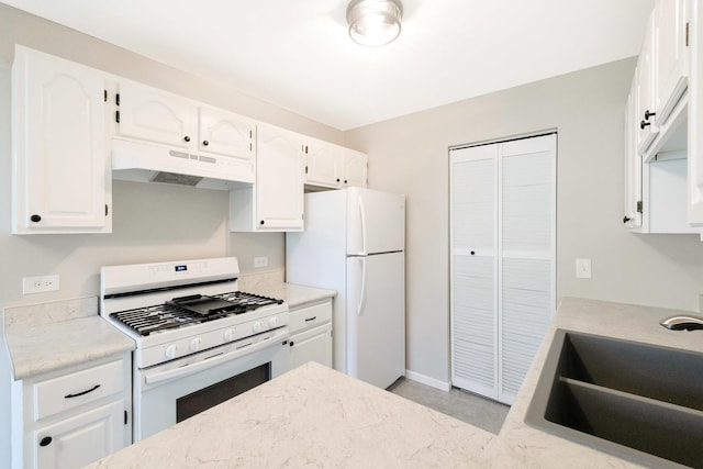 690 Thorntree Ct Unit C1, Bartlett, IL 60103 - kitchen with white appliances, under cabinet range hood, a sink, white cabinets, and baseboards