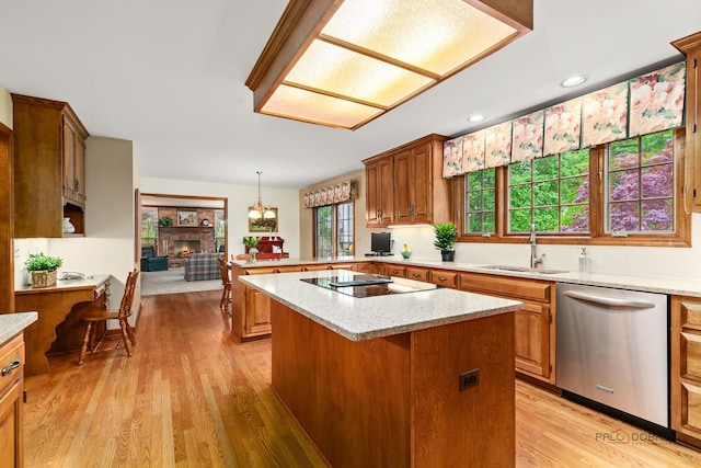 2872 Whispering Oaks Ct, Buffalo Grove, IL 60089 - kitchen featuring stainless steel dishwasher, a sink, a peninsula, black electric stovetop, and a warm lit fireplace