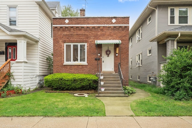 217 Circle Ave, Forest Park, IL 60130 - view of front of house with brick siding, a chimney, and a front yard