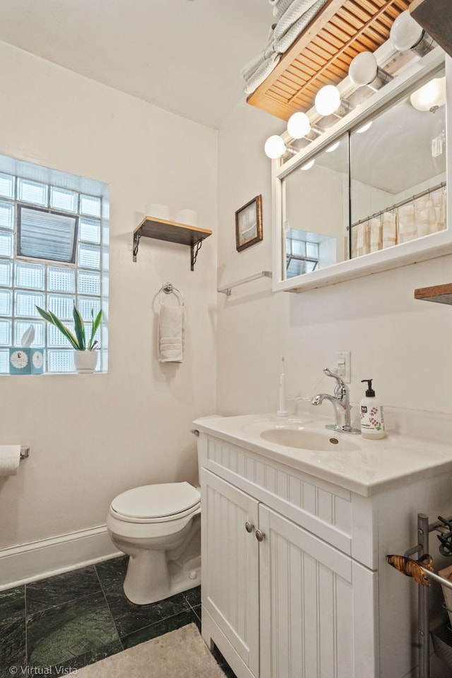 217 Circle Ave, Forest Park, IL 60130 - bathroom with vanity, toilet, baseboards, and curtained shower