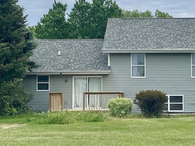 6760 N Summit Dr, Byron, IL 61010 - back of property with a shingled roof and a lawn