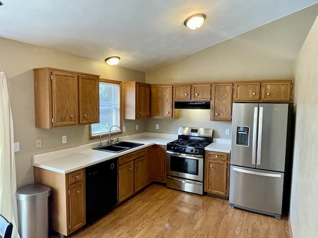 6760 N Summit Dr, Byron, IL 61010 - kitchen featuring stainless steel appliances, under cabinet range hood, a sink, brown cabinets, and lofted ceiling