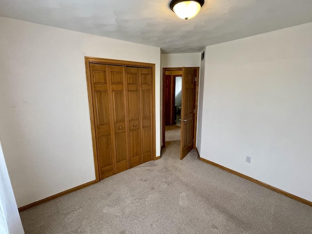 6760 N Summit Dr, Byron, IL 61010 - unfurnished bedroom featuring a closet, light colored carpet, and baseboards