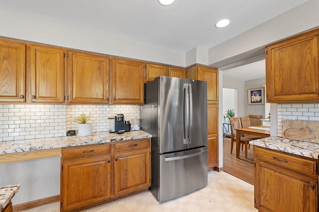 8340 W Monee Manhattan Rd, Monee, IL 60449 - kitchen with freestanding refrigerator, brown cabinets, backsplash, and recessed lighting