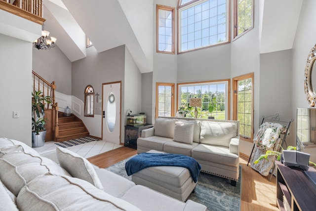 8340 W Monee Manhattan Rd, Monee, IL 60449 - living area featuring a towering ceiling, stairs, wood finished floors, healthy amount of natural light, and a chandelier