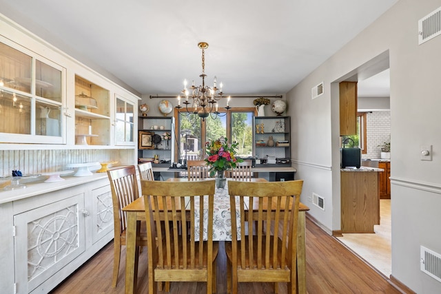 8340 W Monee Manhattan Rd, Monee, IL 60449 - dining room with light wood-type flooring, a chandelier, and plenty of natural light