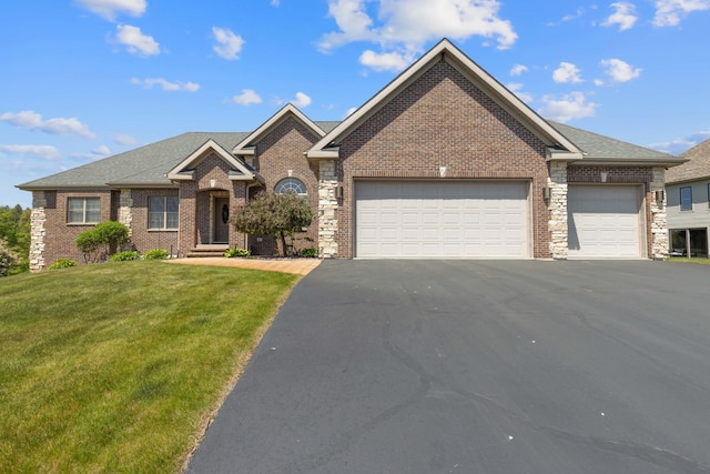 13084 Deer Xing, Roscoe, IL 61073 - view of front of home featuring an attached garage, driveway, a front yard, and brick siding