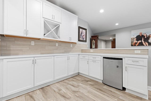 13084 Deer Xing, Roscoe, IL 61073 - kitchen with stainless steel refrigerator, light countertops, a peninsula, white cabinetry, and recessed lighting