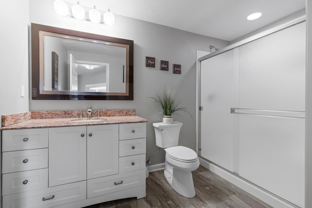 13084 Deer Xing, Roscoe, IL 61073 - bathroom featuring wood finished floors, vanity, toilet, a shower stall, and baseboards