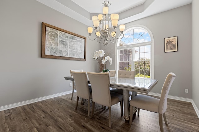 13084 Deer Xing, Roscoe, IL 61073 - dining area with a chandelier, dark wood-type flooring, baseboards, and a tray ceiling
