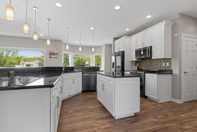 13084 Deer Xing, Roscoe, IL 61073 - kitchen featuring stainless steel appliances, a center island, recessed lighting, tasteful backsplash, and dark wood finished floors