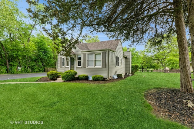 37756 N Cedar Lake Rd, Lake Villa, IL 60046 - view of front of property with a front yard, a chimney, and a shingled roof