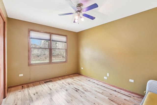 679 Gibbons Dr, New Lenox, IL 60451 - spare room featuring light wood finished floors, ceiling fan, and baseboards