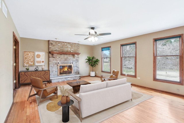 679 Gibbons Dr, New Lenox, IL 60451 - living area with light wood finished floors, a brick fireplace, ceiling fan, and baseboards