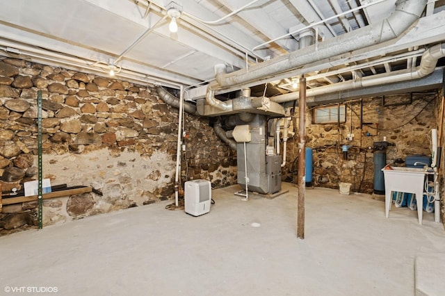 5207 Barnard Mill Rd, Ringwood, IL 60072 - unfinished basement featuring heating unit, a water pressure tank, and a water softener