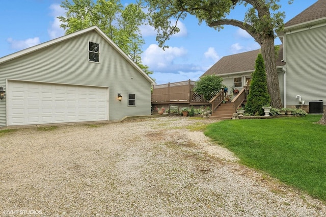 5207 Barnard Mill Rd, Ringwood, IL 60072 - view of front facade with a wooden deck, a detached garage, and a front yard