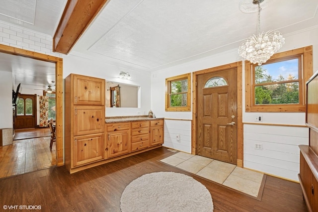 5207 Barnard Mill Rd, Ringwood, IL 60072 - foyer entrance with dark wood-style flooring, a chandelier, and crown molding