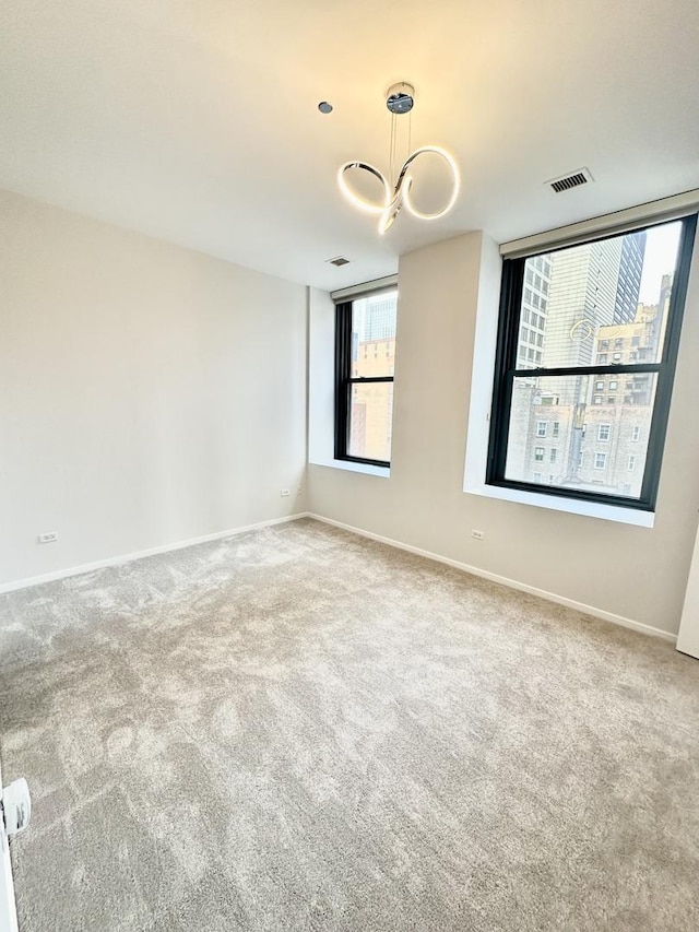 208 W Washington St Unit 1711, Chicago, IL 60606 - spare room featuring a chandelier, carpet, and plenty of natural light