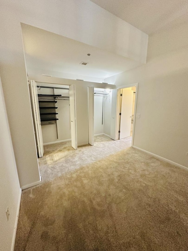 208 W Washington St Unit 1711, Chicago, IL 60606 - unfurnished bedroom featuring two closets, light colored carpet, and baseboards