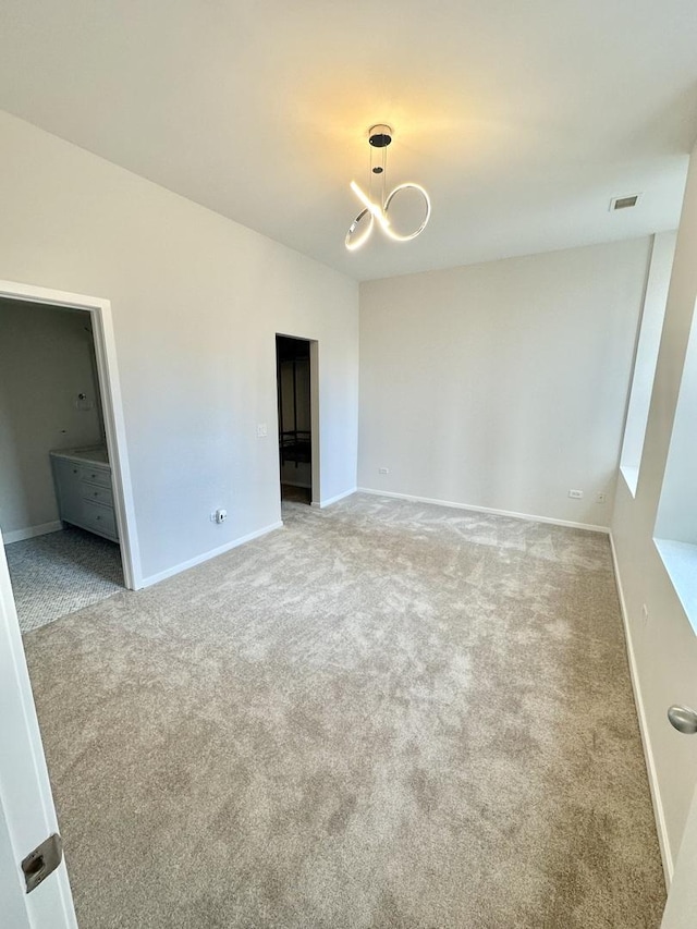 208 W Washington St Unit 1711, Chicago, IL 60606 - unfurnished room featuring carpet, baseboards, and a chandelier