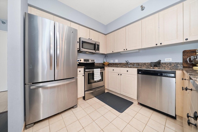 512 N Mcclurg Ct Unit 705, Chicago, IL 60611 - kitchen with stainless steel appliances, light tile patterned floors, and dark stone counters