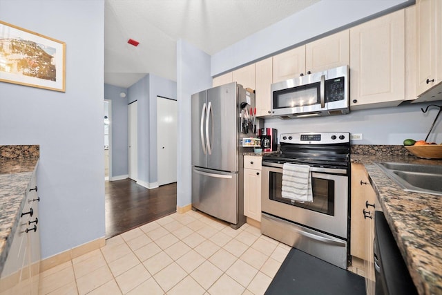 512 N Mcclurg Ct Unit 705, Chicago, IL 60611 - kitchen with appliances with stainless steel finishes, dark countertops, light tile patterned floors, and white cabinets